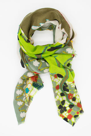 A styled scarf with nature patterns in green, red and black.