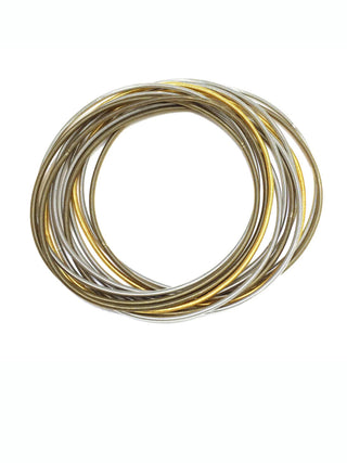 Set of piano wire bracelets in various tones of gold, silver and bronze.