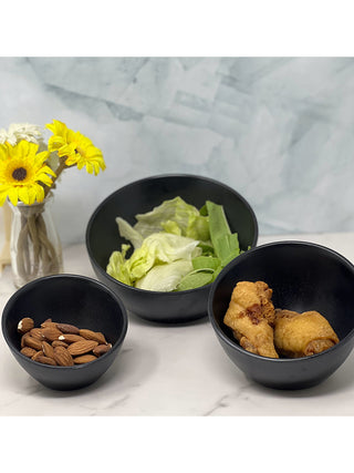 Three black sumi bowls in different sizes holding snacks (the 6" black sumi bowl in the back).