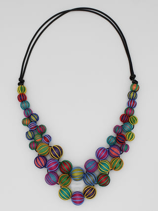A necklace with multicolor beads, expertly wrapped and closely knotted for a luxurious and exclusive look, on a leather chain.