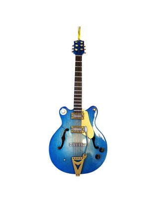 An ornament that looks like a blue electric guitar, with a gold cord for hanging.