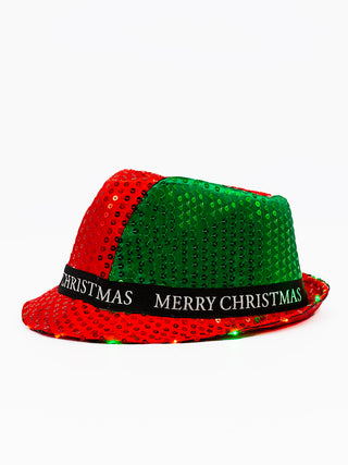 A red and green fedora hat with MERRY CHRISTMAS on its band, and red and green lights on its brim.