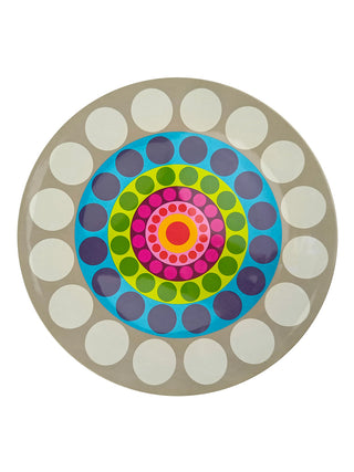 A round platter with a colorful pattern of concentric dots.