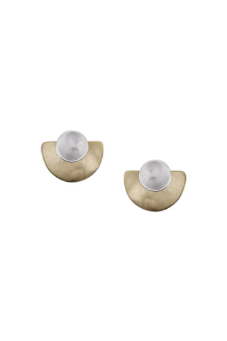A dished silver disc on top of a lightly hammered brass semi circle clip earring. A pair are shown.