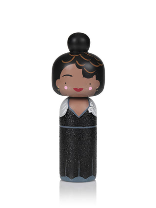 A Japanese Kokeshi doll in the form of jazz singer Ella Fitzgerald.