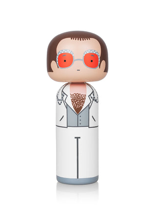 Elton John as a wooden Japanese Kokeshi doll, complete with orange shades and white suit.