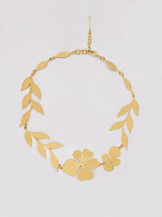A gold necklace with a floral pattern.