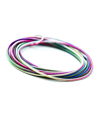 A bracelet comprised of different colored loops of piano wire.