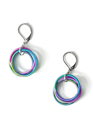 A pair of colorful earrings made from loops of piano wire, with wire hooks.