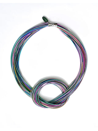 A necklace made of multi-colored strands of piano wire with a large knot at the bottom and a magnetic clasp at the top.