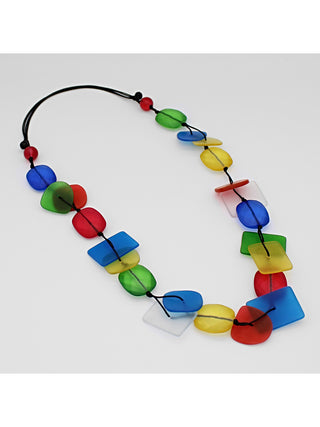 Angled view of a colorful resin bead necklace, flat, with a variety of shapes and colors. 