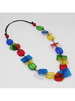 Angled view of a colorful resin bead necklace, flat, with a variety of shapes and colors.