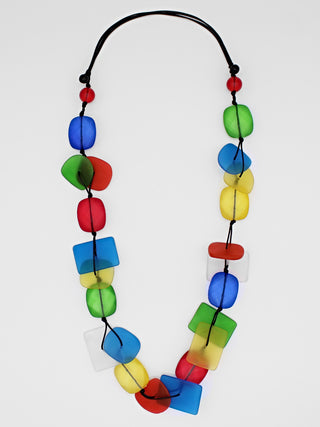 A colorful resin bead necklace, flat, with a variety of shapes and colors.