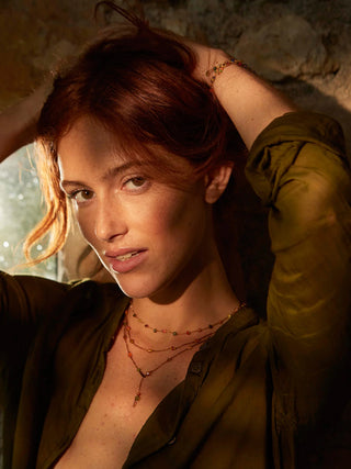 A model wearing multiple Loopy necklaces.