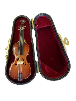 A lapel pin that looks like a cello, in a red, velvet-lined case.