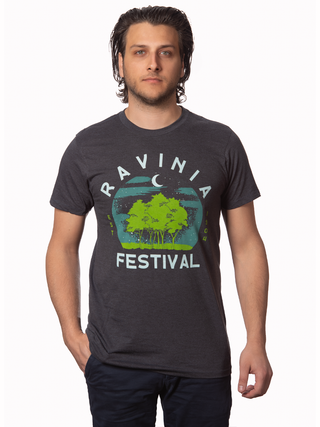 A young man with a hand in his pocket, wearing a t-shirt that reads, Ravinia Festival, with a rendition of moon over green trees.