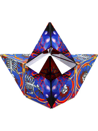 A geometric shape with cubes and triangles featuring the Grateful Dead's skull with roses design, in blue, orange and red.