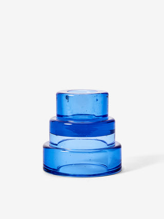 A blue, three-tiered glass candle holder.