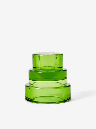 A green, three-tiered glass candle holder.