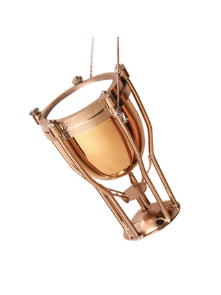An ornament that looks like a gold timpani, with a silver cord for hanging.