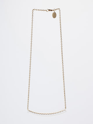 A brass necklace styled as a rectangle, with the lower part encased in clear glass.