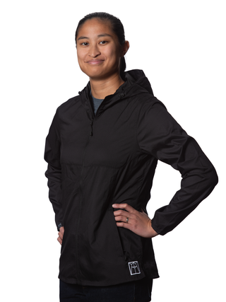 A smiling young woman modeling a black windbreaker with the Ravinia logo on her left hip.