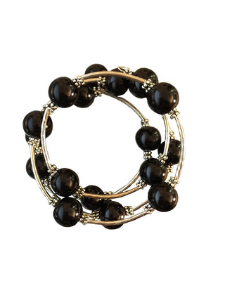 A silver wrap bracelet with black beads.