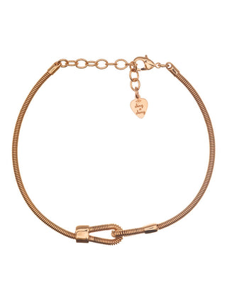 Overhead view of a gold bracelet made from a bass guitar string.