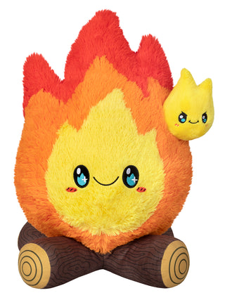 A smiling plush version of a campfire, red, yellow and orange on top of logs.