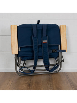 The padded beach chair folded up, with backpack straps for easy transportation.