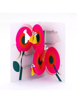 An open white pop-up card with pink poppies and yellow and pink insects.