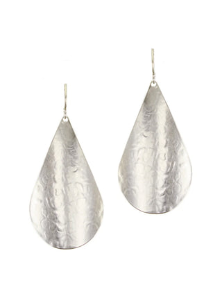 A pair of large silver teardrop earrings.