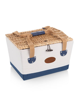 A canvas picnic basket with blue trim, tan carrying straps, and a wicker lid, with a leather engraved plate with the Ravinia logo.