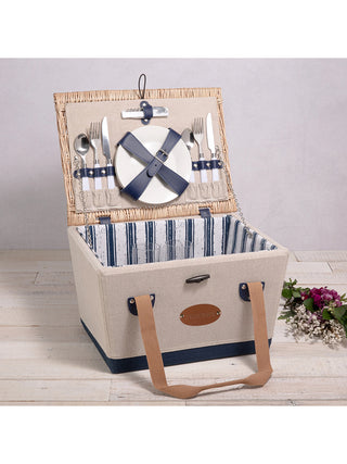 A picnic basket with its lid open to display the cutlery sets held by blue straps, and a white and blue striped interior.