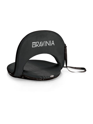 A black foldable reclining seat with a shoulder strap shown from the back, branded with the Ravinia logo in white.
