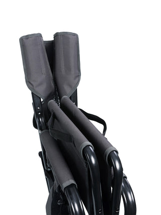 Close-up of the gray rocking chair, folded up and displaying the short carrying straps.