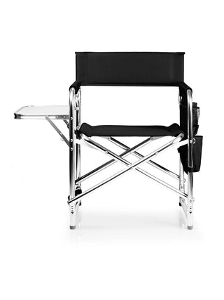 A black folding sports chair with a small side table and an armrest caddy, shown from the front.