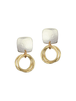 Silver square post earrings with a bunch of brass rings hanging from them.