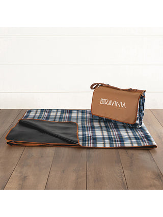 One blanket tote folded to show the soft fleece top and the waterproof back, and another folded into a compact carry tote, emblazoned with the Ravinia logo.