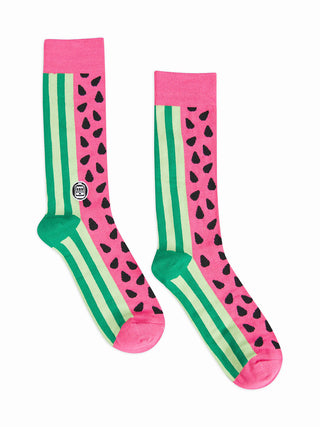 Socks with green stripes representing watermelon rind, and seeds on pink.
