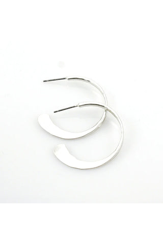 Silver-toned circular post earrings with texture visible.