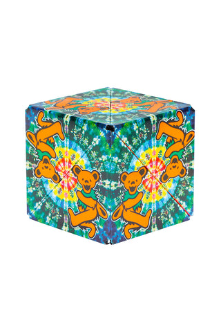 A cube with dancing bears and and a tie-dye type pattern in the background.