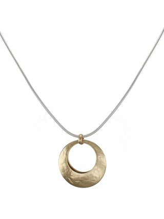 Two back-to-back brass cutout discs on a long silver snake chain