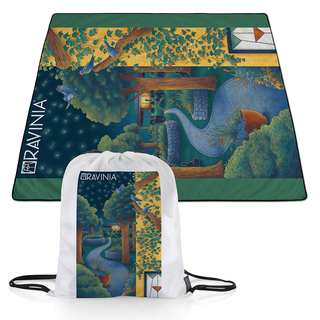 A blanket depicting the inviting path leading to the glowing music pavilion, with the Martin Theatre and one of its stained-glass windows in the foreground. Plant holders rich with flowers and lush trees line the path, while three bluebirds watch over the scene. The blanket's carrying bag is in the foreground.