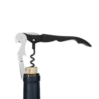The exclusive five-turn worm & foil cutter from the black Ravinia Corkscrew is inserted in a cork, with its double-hinged arm against the bottle’s rim.