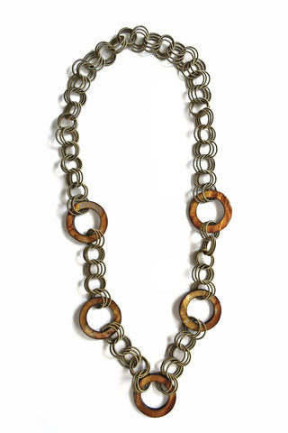 Five tortoiseshell-toned mother-of-pearl discs accent springy rings of soft, supple piano wire.