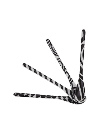 Four spoons touching at the tip and fanning out, each with a unique black-and-white pattern.