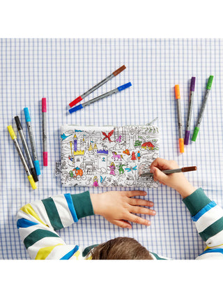 An overhead view of a child coloring on the fairly tale pencil case.