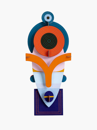 A colorful cardboard mask with an angular bottom and round top.