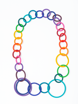 A rainbow necklace made of various sized rings.